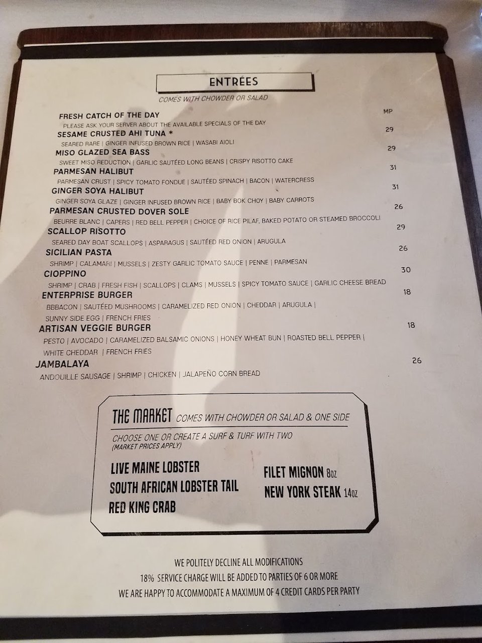 Happy hour menu beside a restaurant table.